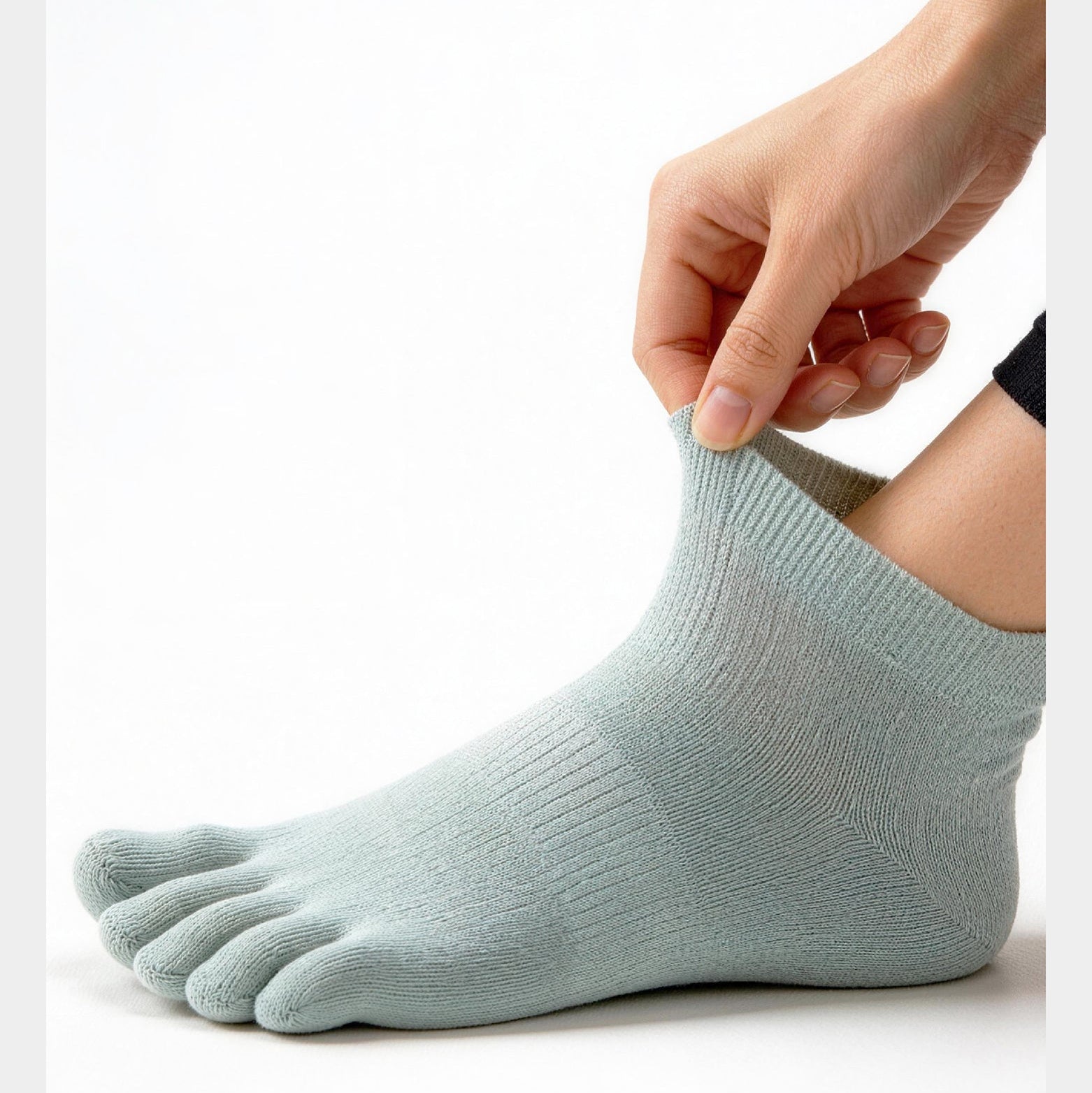 Person wearing a light blue sock with text on a white background