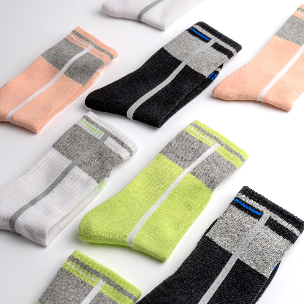 Collection of colorful EFISIO All-Day Running socks with striped patterns on a light background