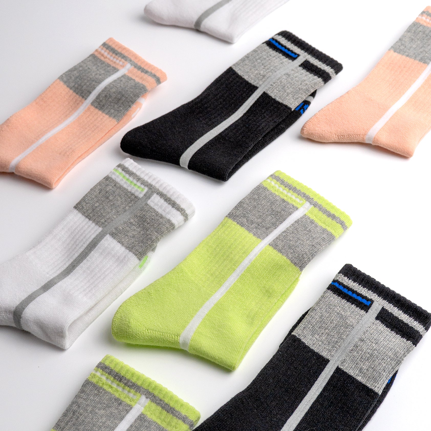 Collection of colorful EFISIO All-Day Running socks with striped patterns on a light background