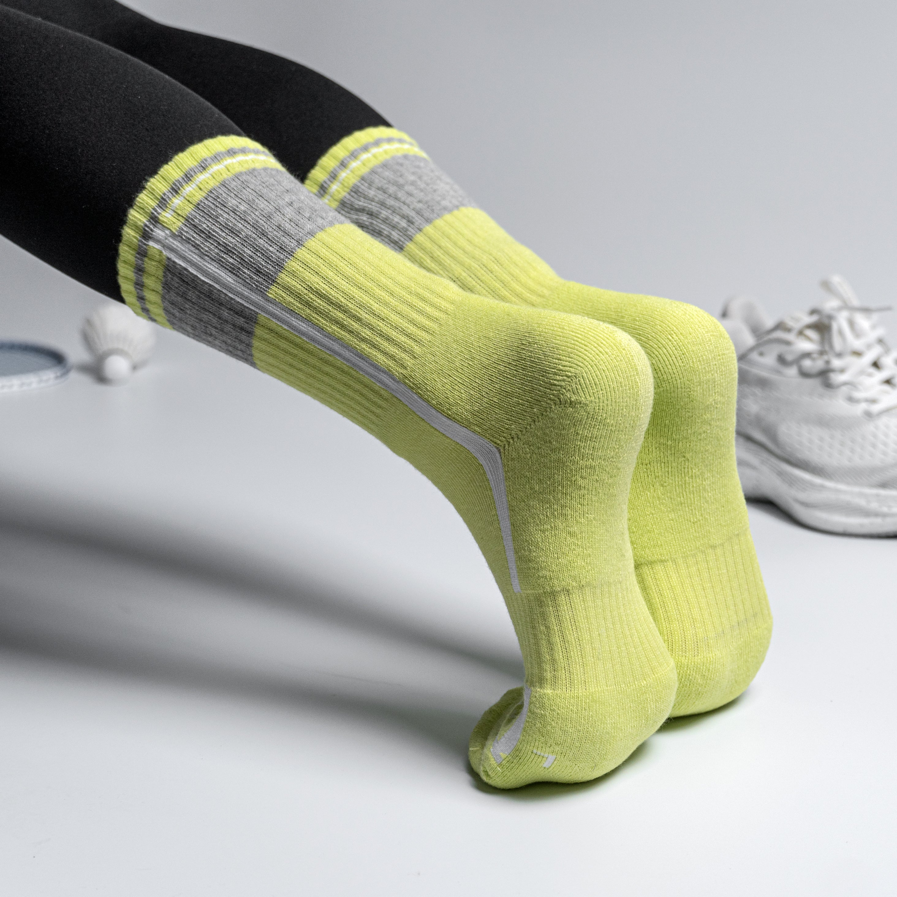 Yellow and gray EFISIO All-Day Running socks worn by a person on a light gray background