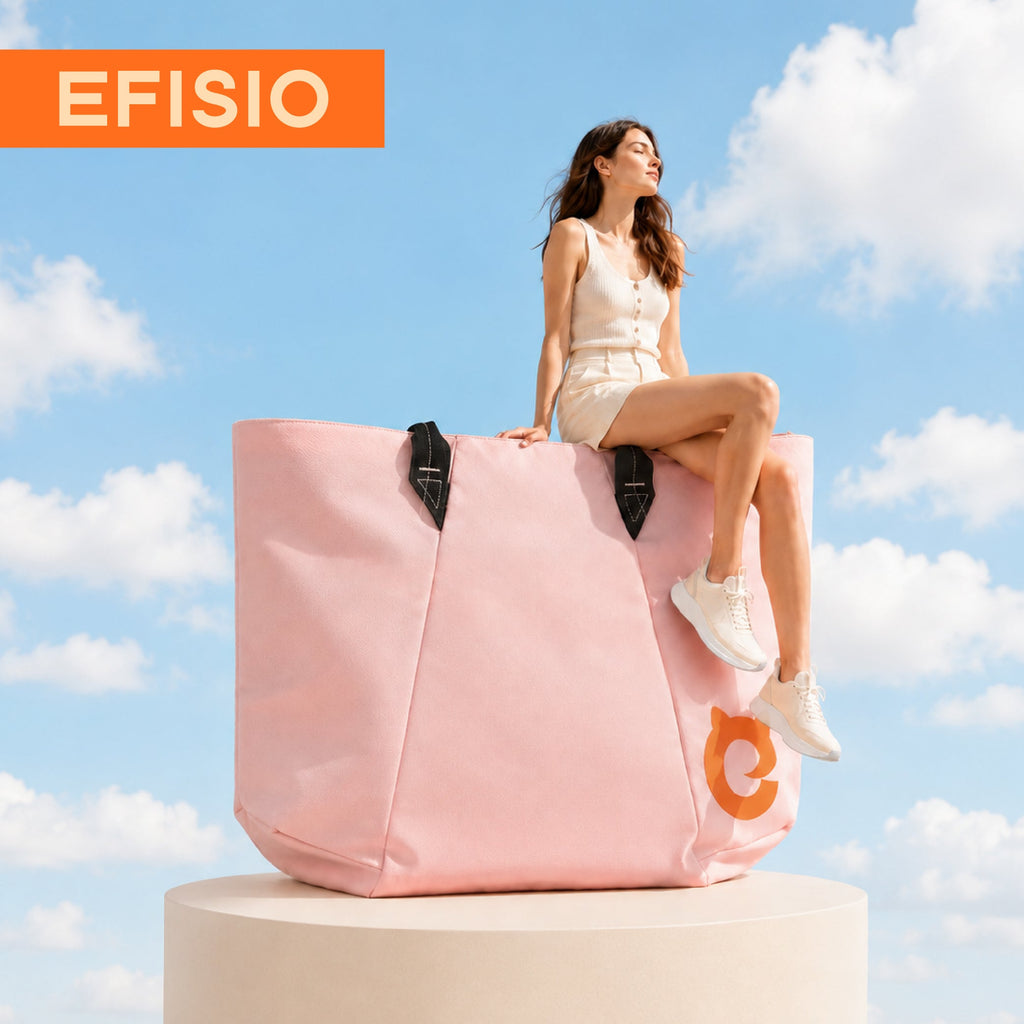 Woman sitting on a large EFISIO Avelina Tote Bag with 'EFISIO' branding against a blue sky.