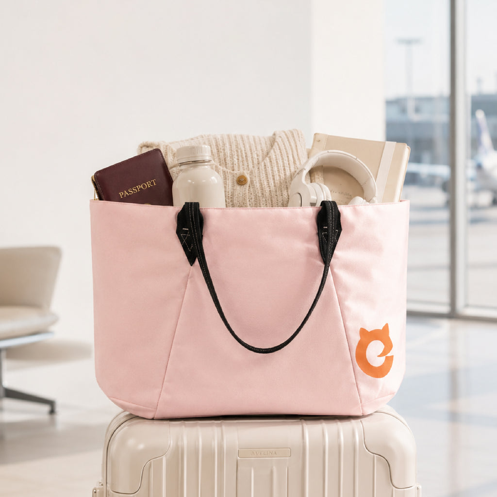 Pink EFISIO Avelina Tote Bag with travel items on a suitcase in an airport setting