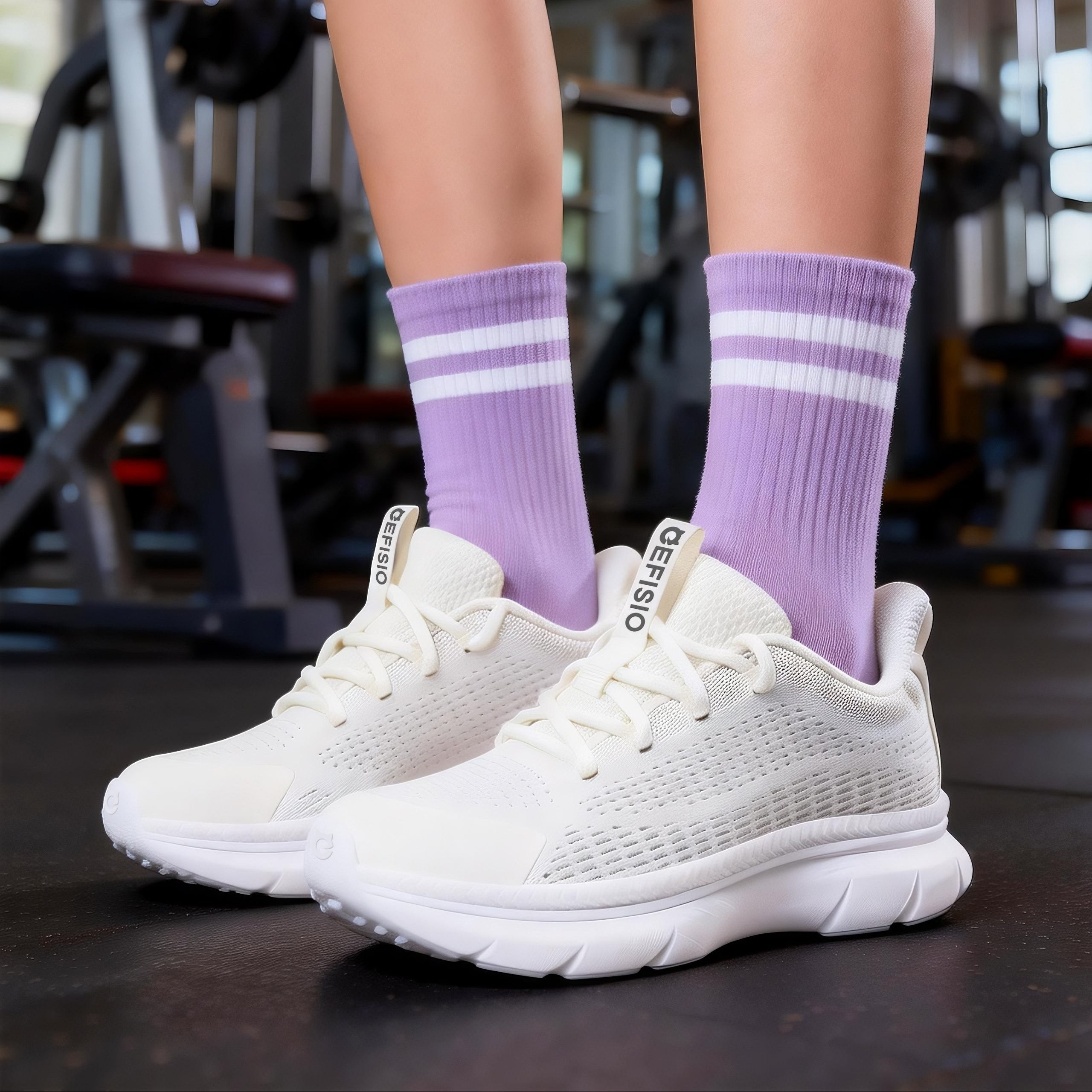 Person wearing white EFISIO Flying III Athletic Shoes with white stripes in a gym setting