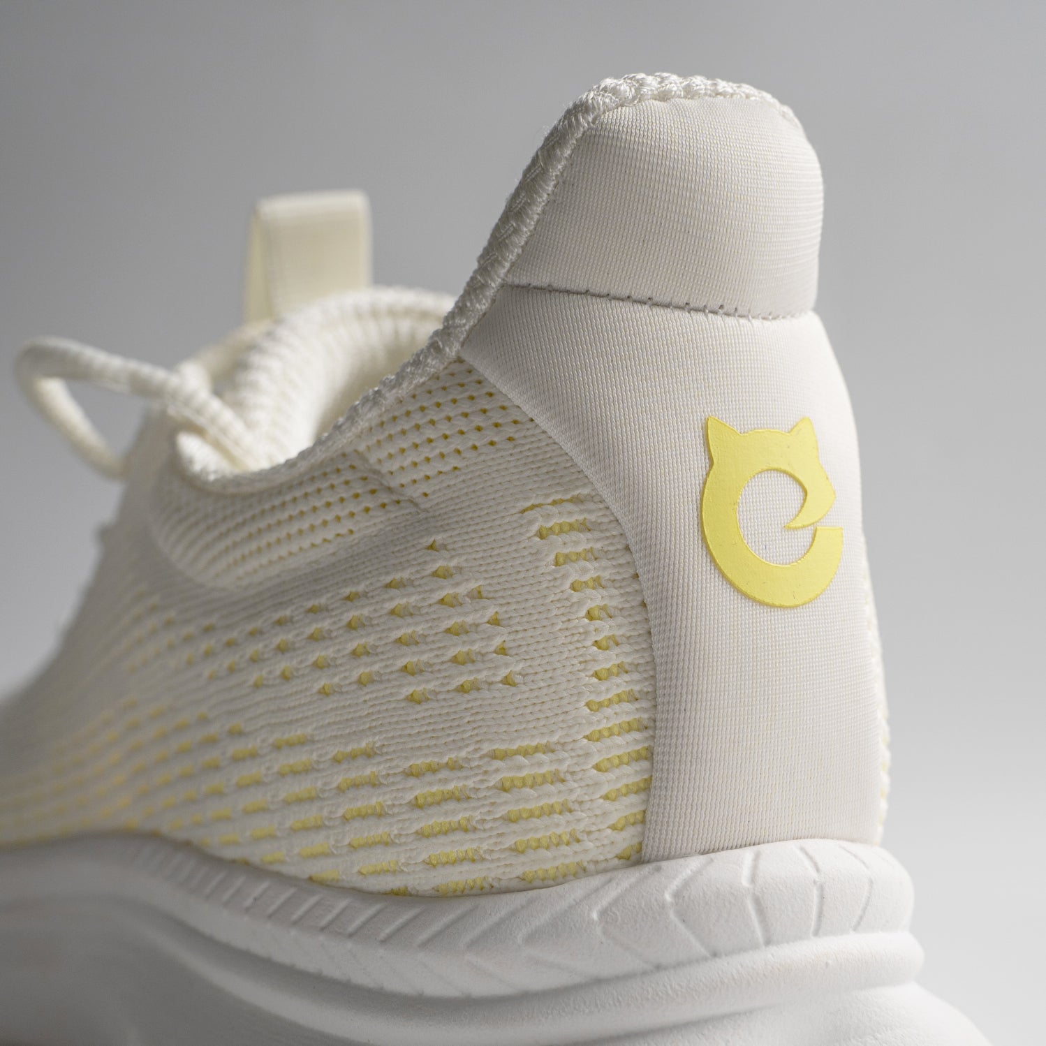 White EFISIO Flying III Athletic Shoes with a yellow logo on a gray background