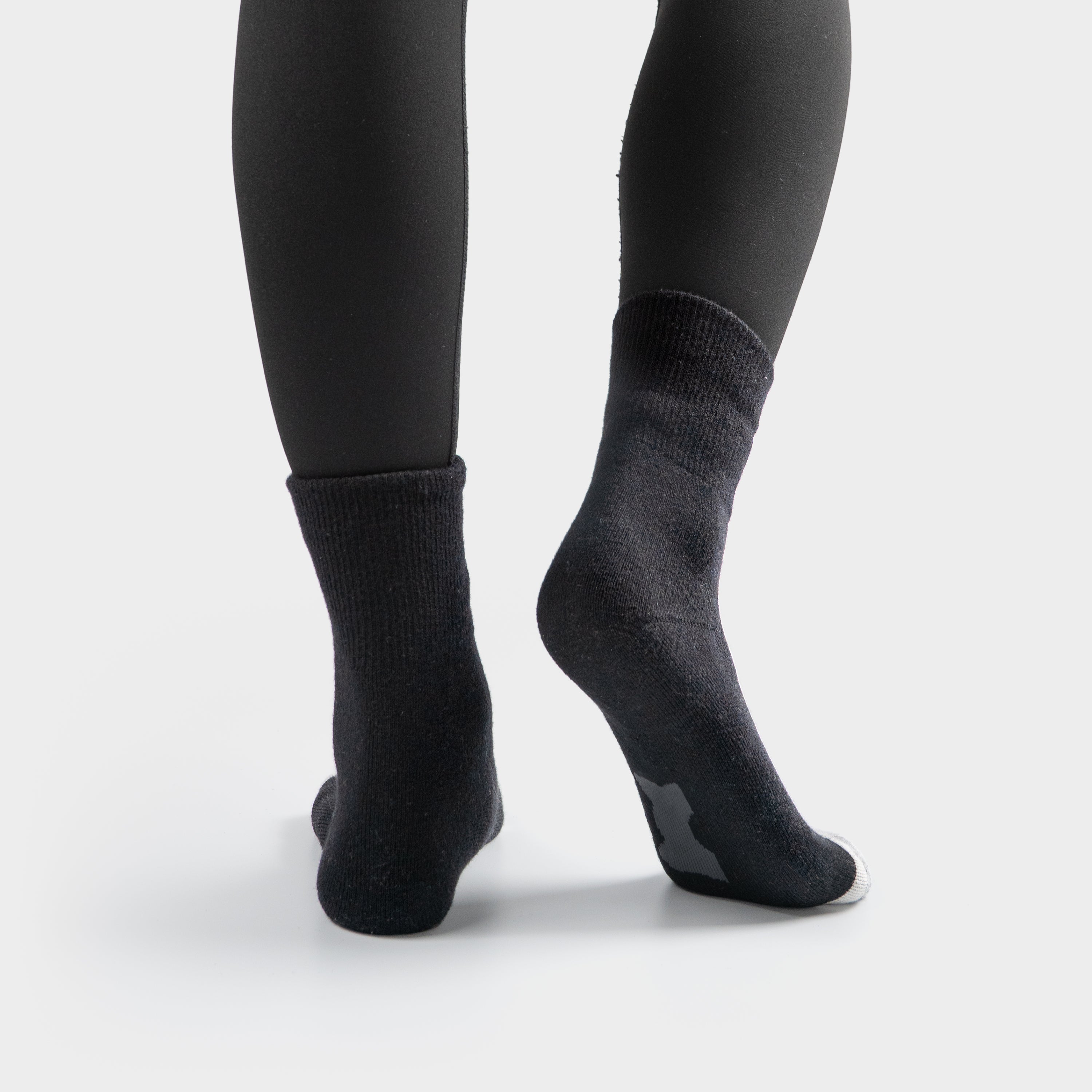 Black EFISIO Merino Wool Crew socks worn with black leggings on a white background