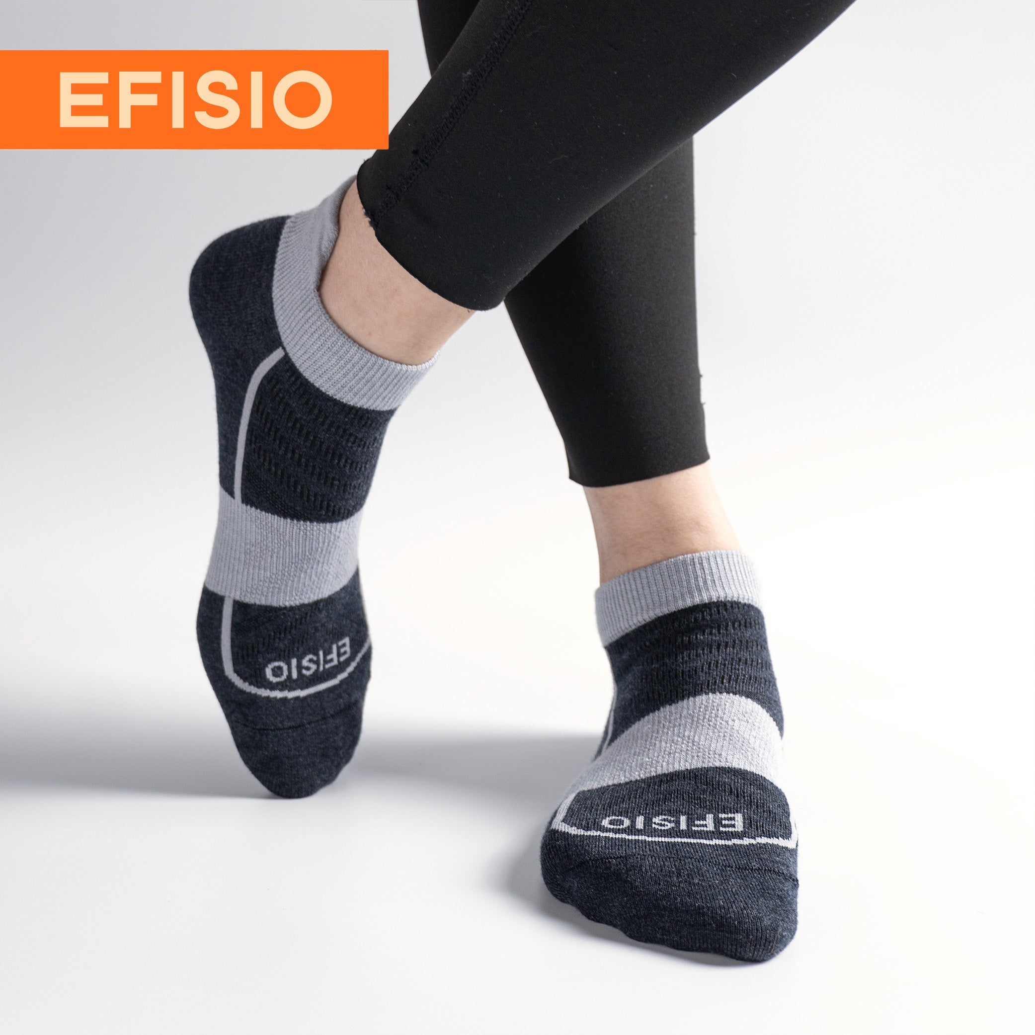 Person wearing black and gray EFISIO Merino Wool Tab socks with 'EFISIO' branding on a light gray background