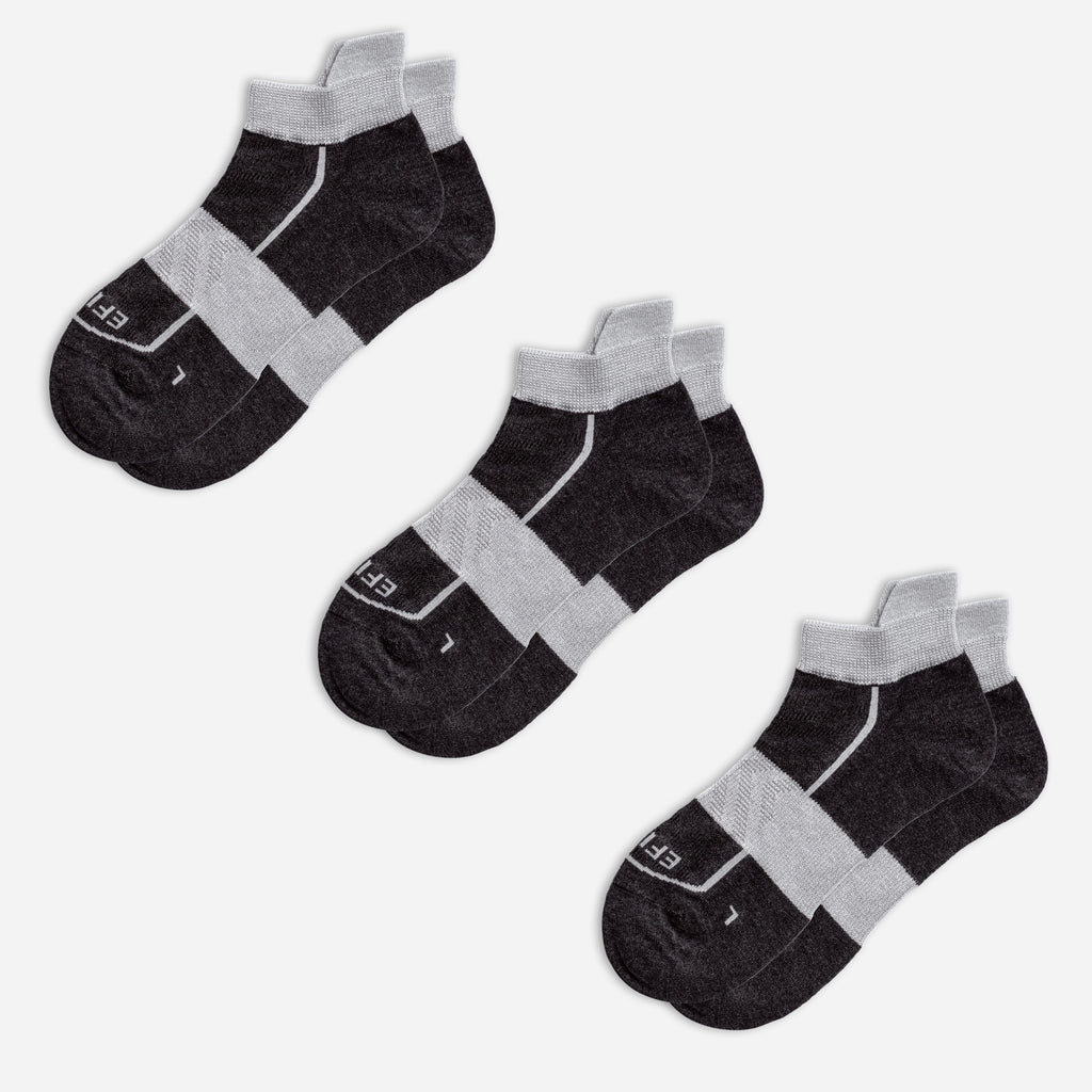 Three pairs of black EFISIO Merino Wool Tab ankle socks with gray accents on a white background