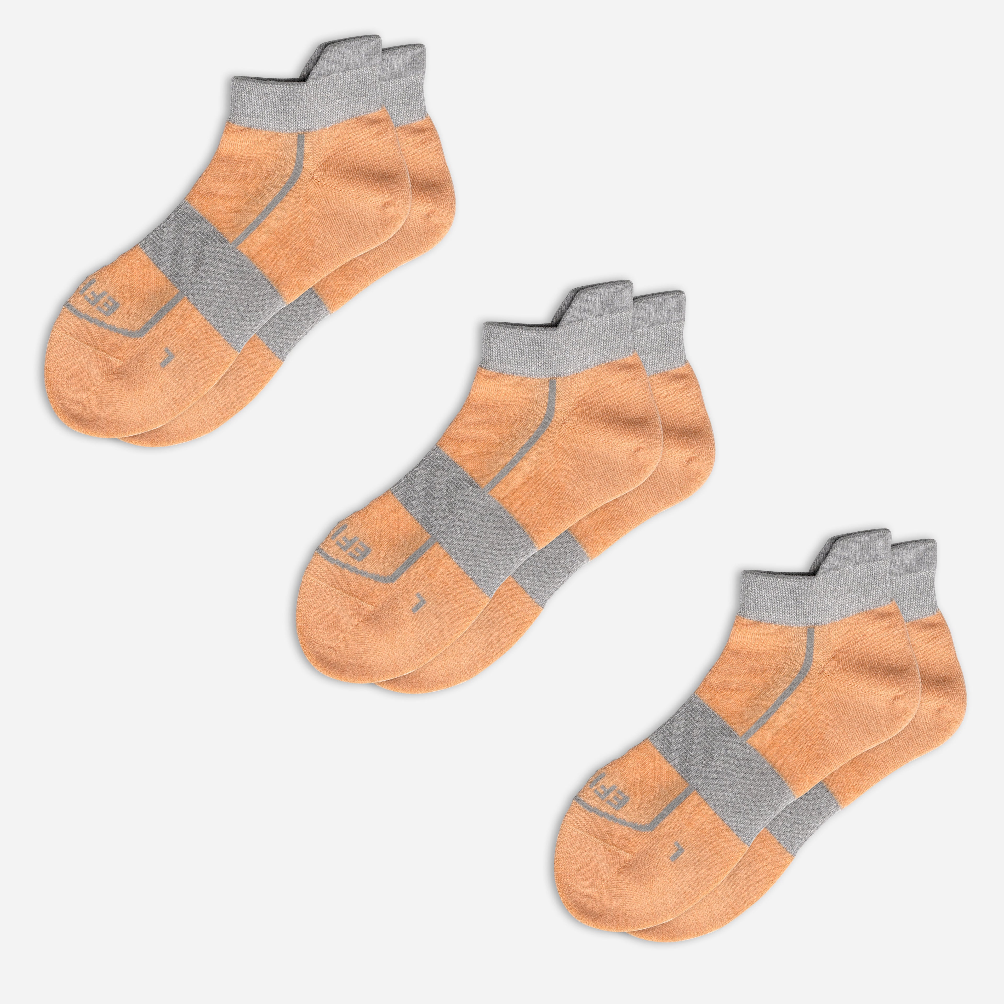 Three pairs of orange EFISIO Merino Wool Tab socks with gray accents on a white background