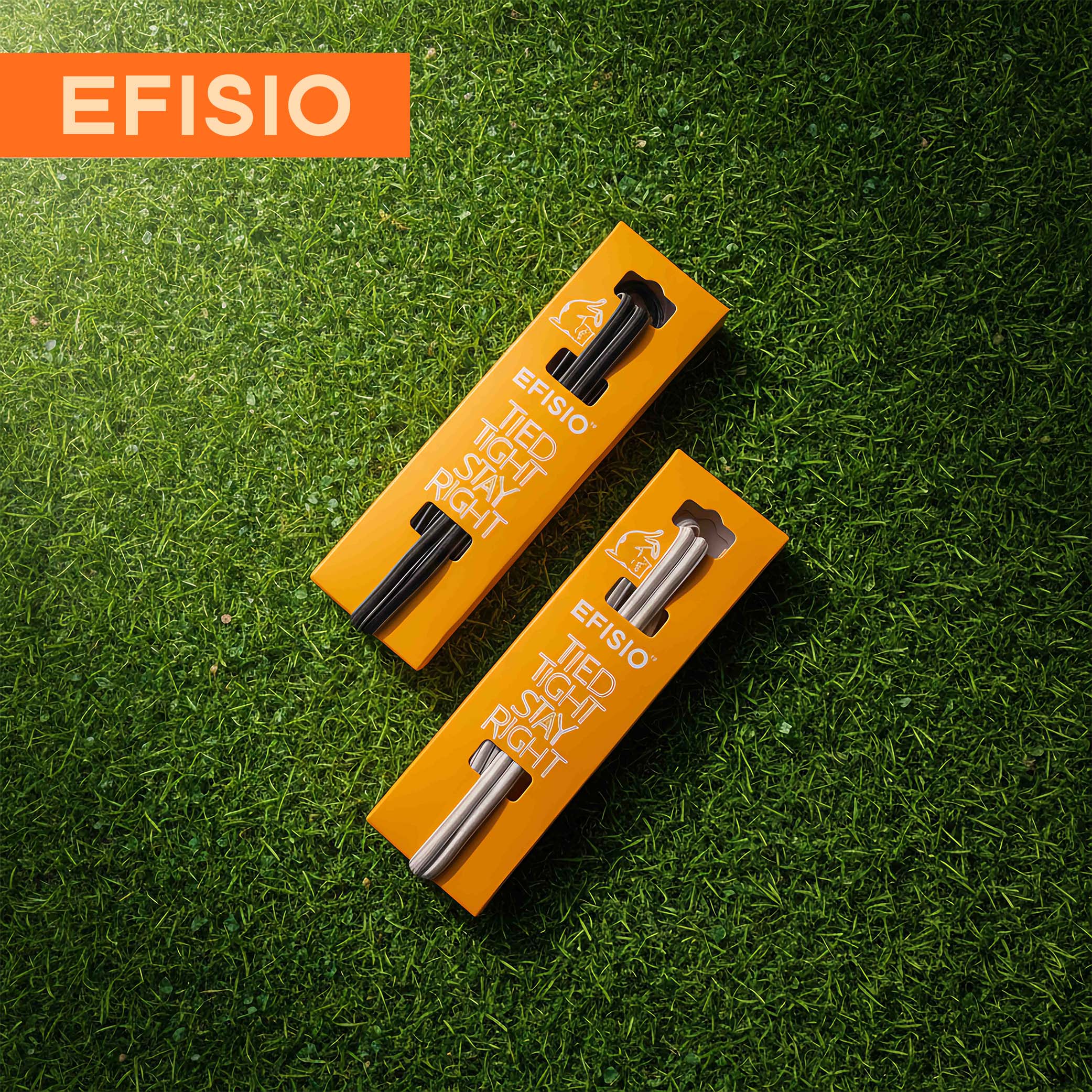 Two orange packaging boxes with black and silver elastic shoelaces on a green grass background